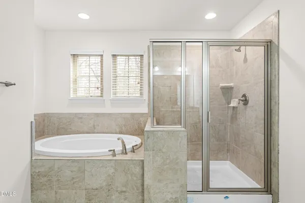 a bathroom with a bathtub and a shower