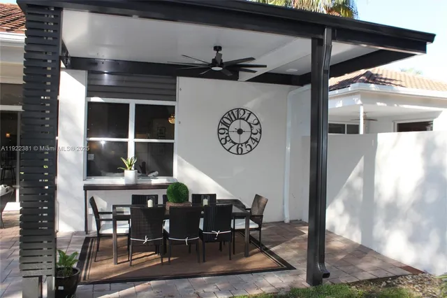 a view of a dinning table and chairs in patio