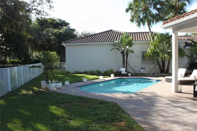a view of a house with backyard and sitting area