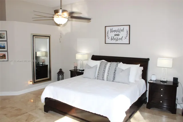 a bedroom with bed and wooden floor