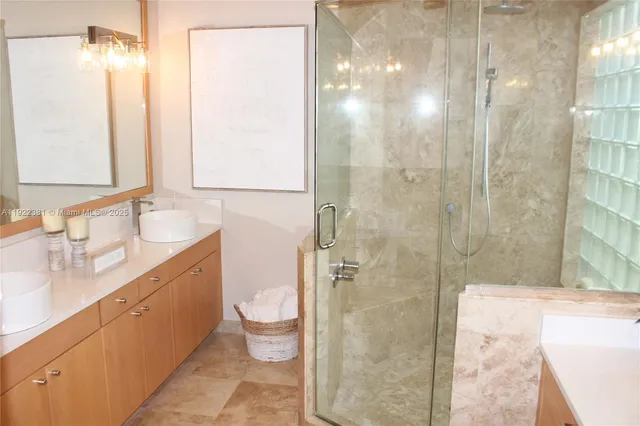 a bathroom with a double vanity sink toilet and shower