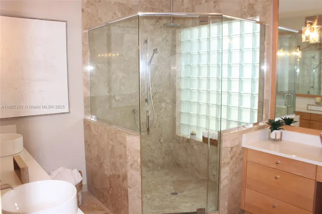 a bathroom with a shower and a sink