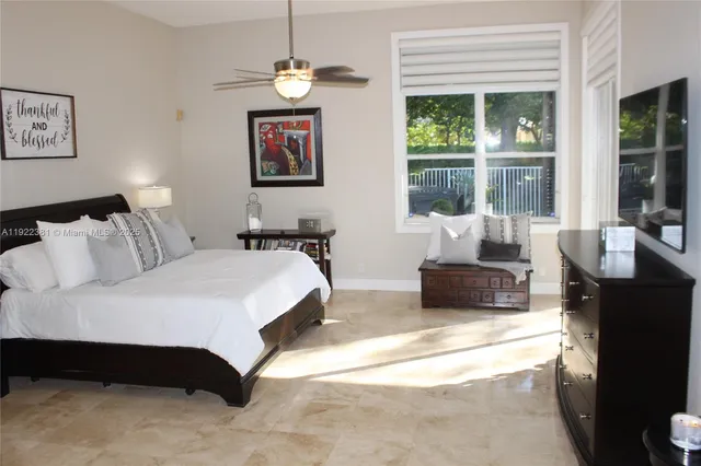 a spacious bedroom with a bed window and couch