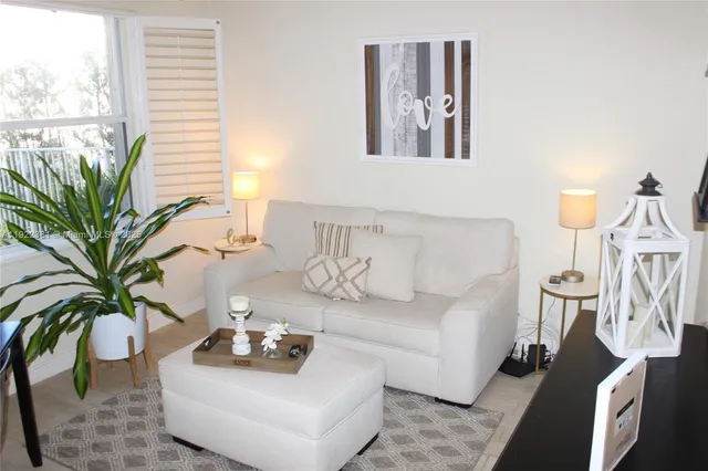 a living room with furniture and a potted plant