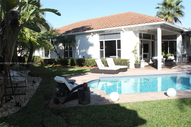 a view of a house with backyard porch and sitting area