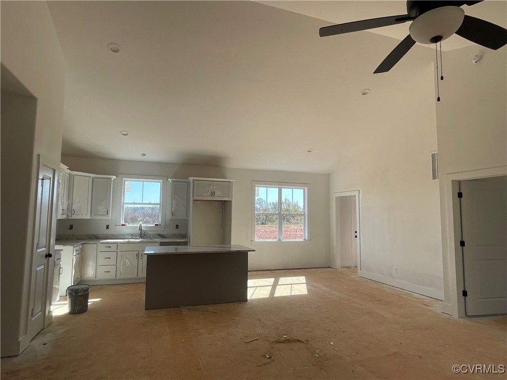 4724 Country Club Road La Crosse, VA 23950 - Photo 5 of 17 a view of a kitchen with a sink and dishwasher a refrigerator with white cabinets