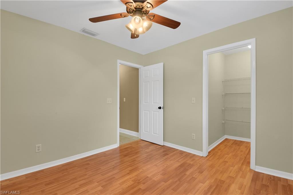 17557 Butler Road Fort Myers, FL 33967 - Photo 29 of 35 an empty room with wooden floor closet and fan