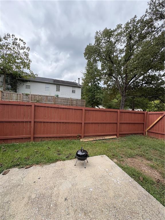 701 Pine Tree Trail, Unit 10E Atlanta, GA 30349 - Photo 16 of 33 a backyard of a house with lots of green space
