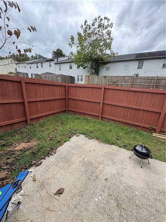 701 Pine Tree Trail, Unit 10E Atlanta, GA 30349 - Photo 17 of 33 a backyard of a house with a garden and plants