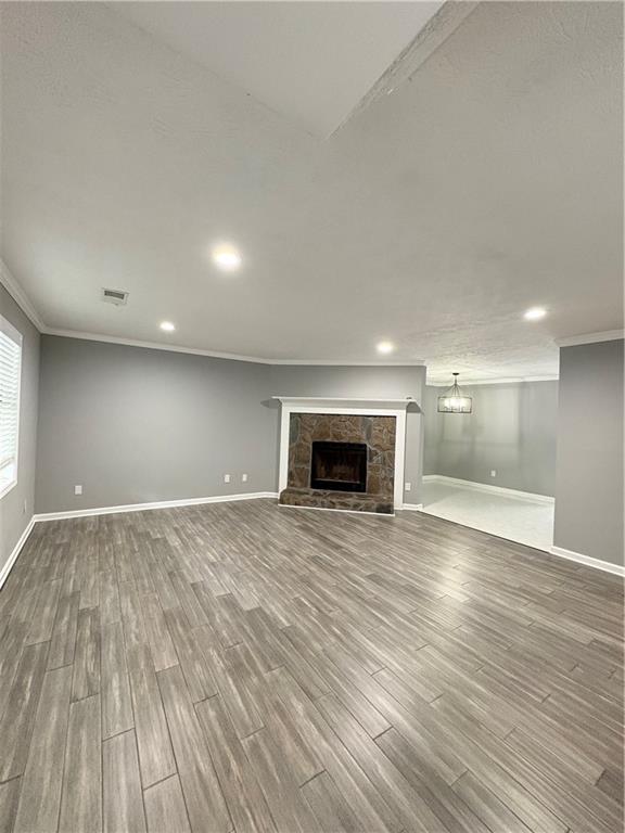 701 Pine Tree Trail, Unit 10E Atlanta, GA 30349 - Photo 5 of 33 an empty room with wooden floor and fireplace