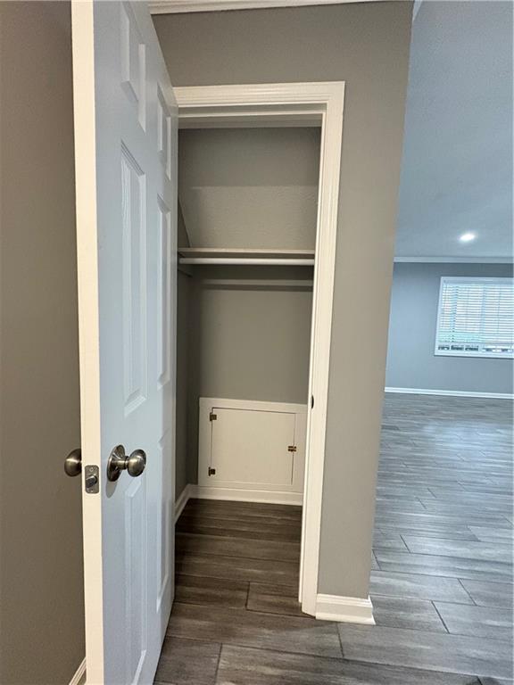 701 Pine Tree Trail, Unit 10E Atlanta, GA 30349 - Photo 10 of 33 a view of a hallway with wooden floor and closet