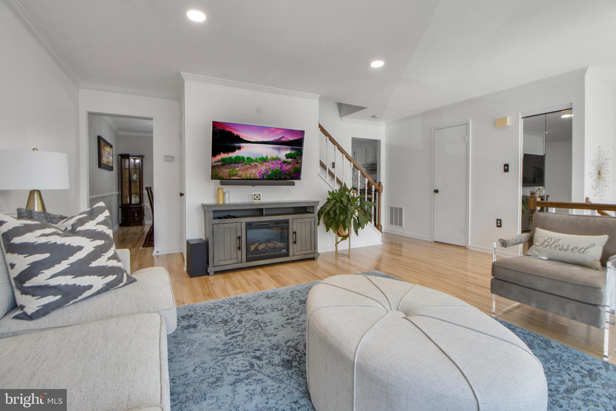 14432 Bakersfield Court Silver Spring, MD 20906 - Photo 12 of 60 a living room with furniture and a flat screen tv