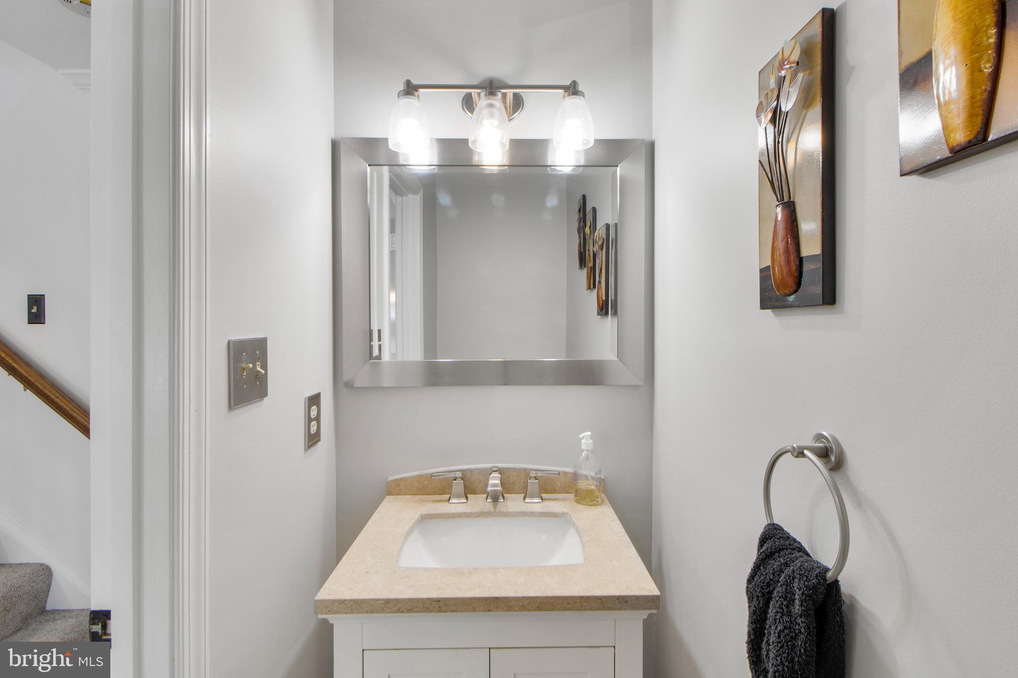 14432 Bakersfield Court Silver Spring, MD 20906 - Photo 16 of 60 a bathroom with a sink and mirror