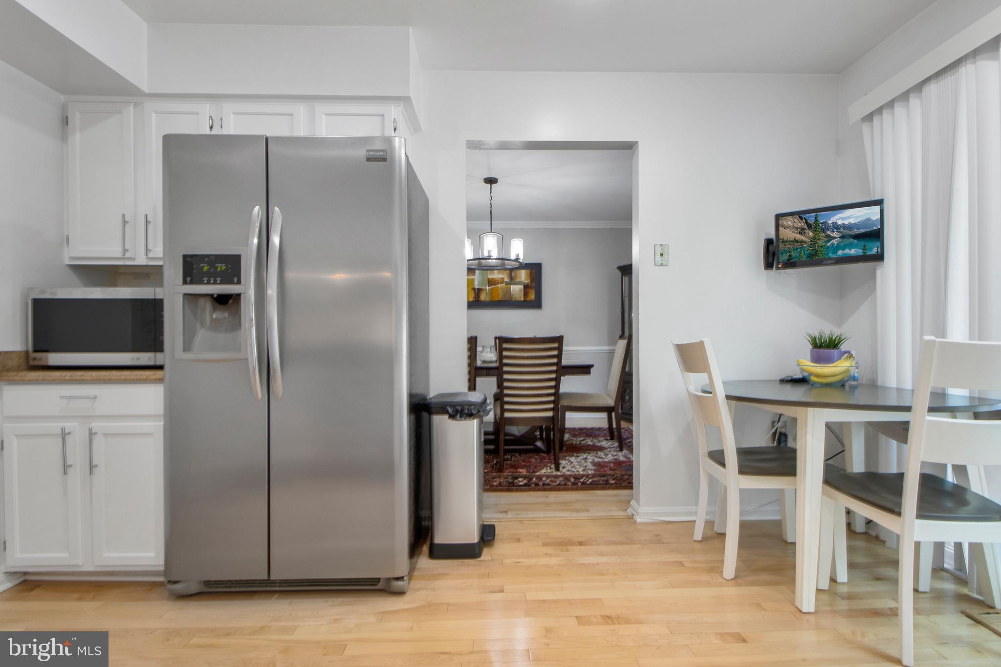 14432 Bakersfield Court Silver Spring, MD 20906 - Photo 21 of 60 a kitchen with stainless steel appliances granite countertop a refrigerator and a stove top oven
