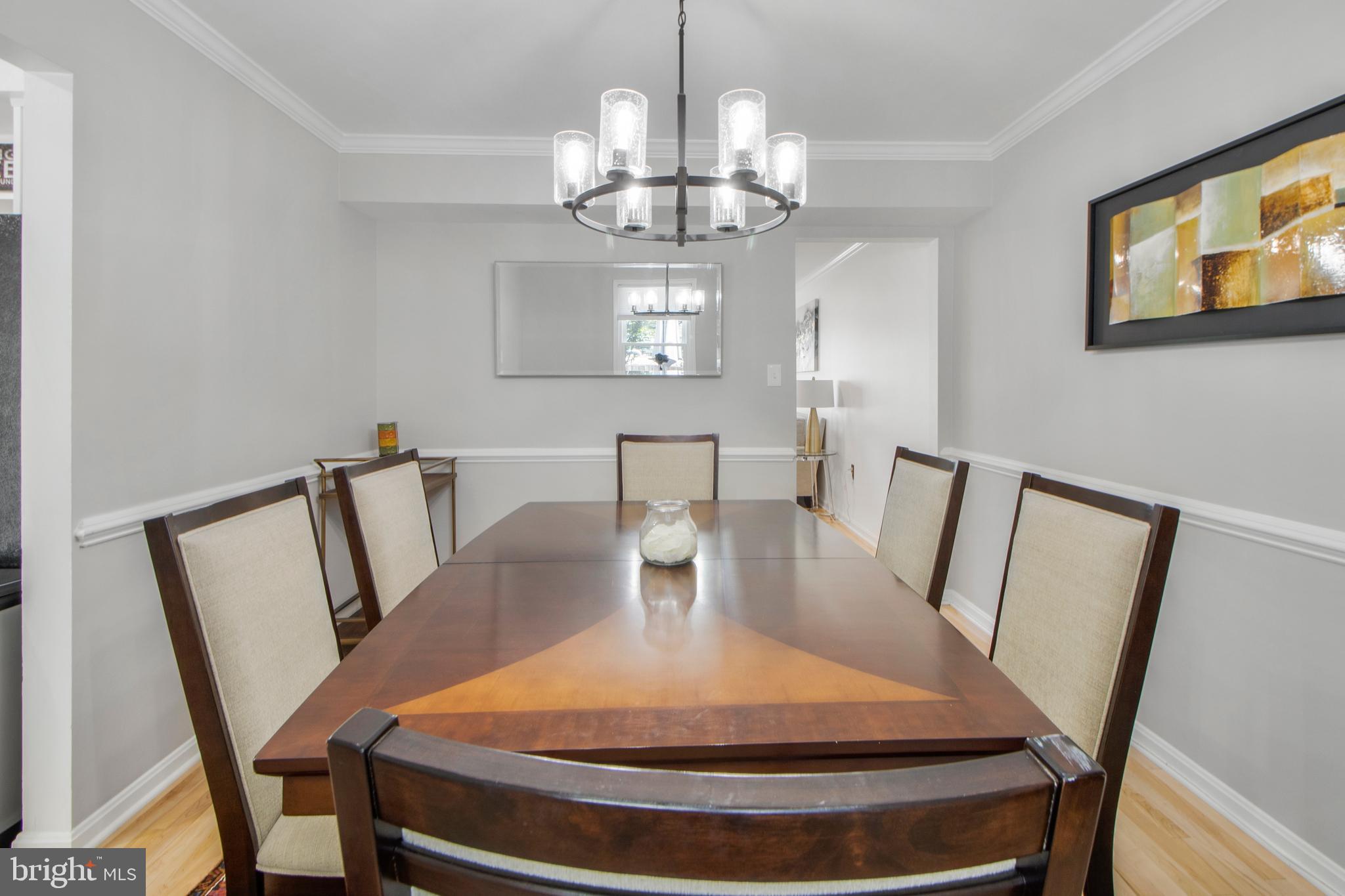 14432 Bakersfield Court Silver Spring, MD 20906 - Photo 25 of 60 a view of a dining room with furniture a chandelier and wooden floor