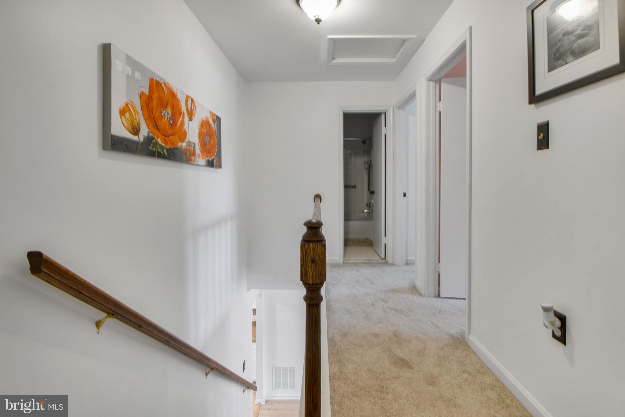 14432 Bakersfield Court Silver Spring, MD 20906 - Photo 28 of 60 a view of a hallway with paintings on the wall