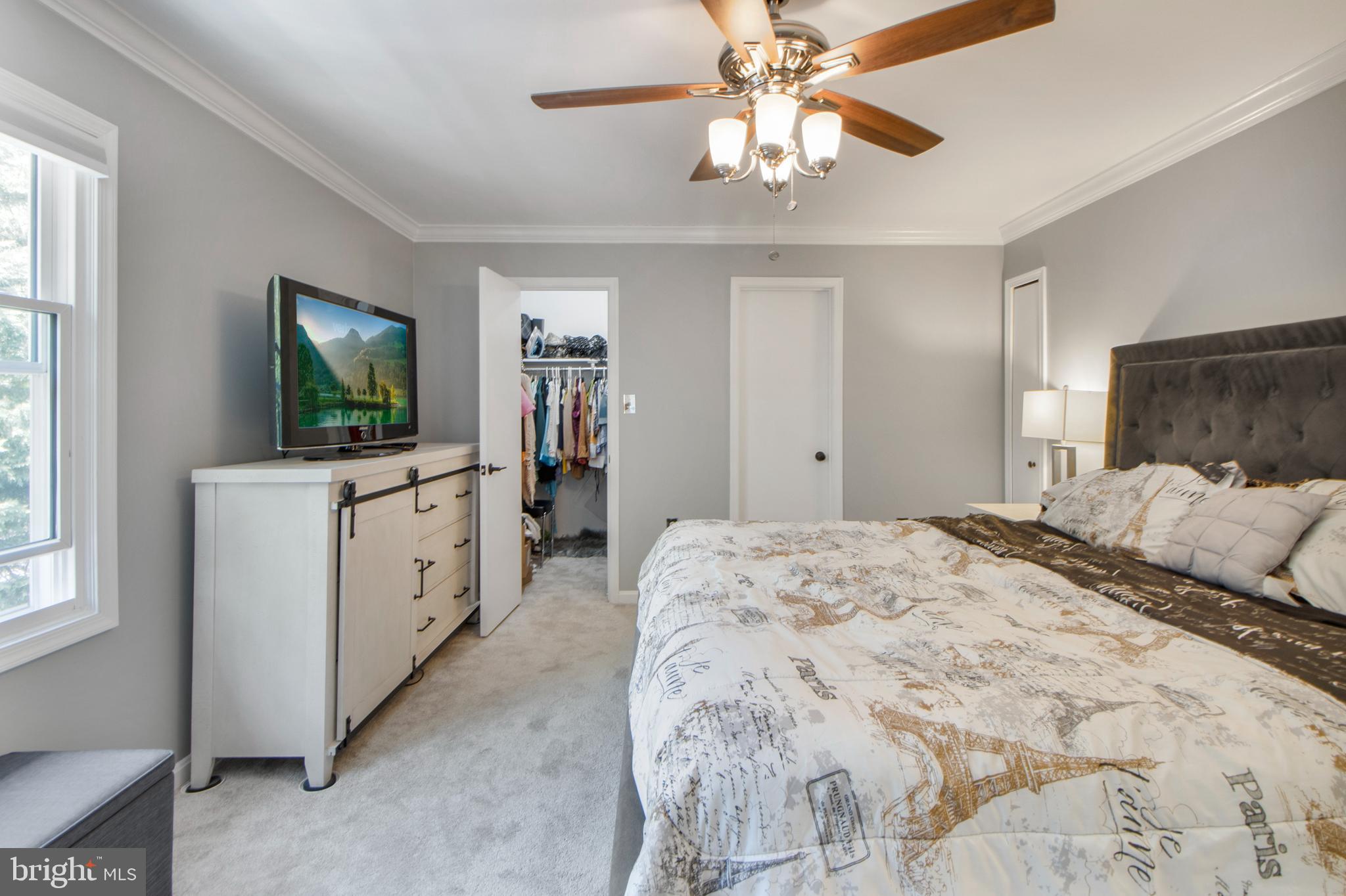 14432 Bakersfield Court Silver Spring, MD 20906 - Photo 36 of 60 a bedroom with a large bed and a flat tv screen on dresser