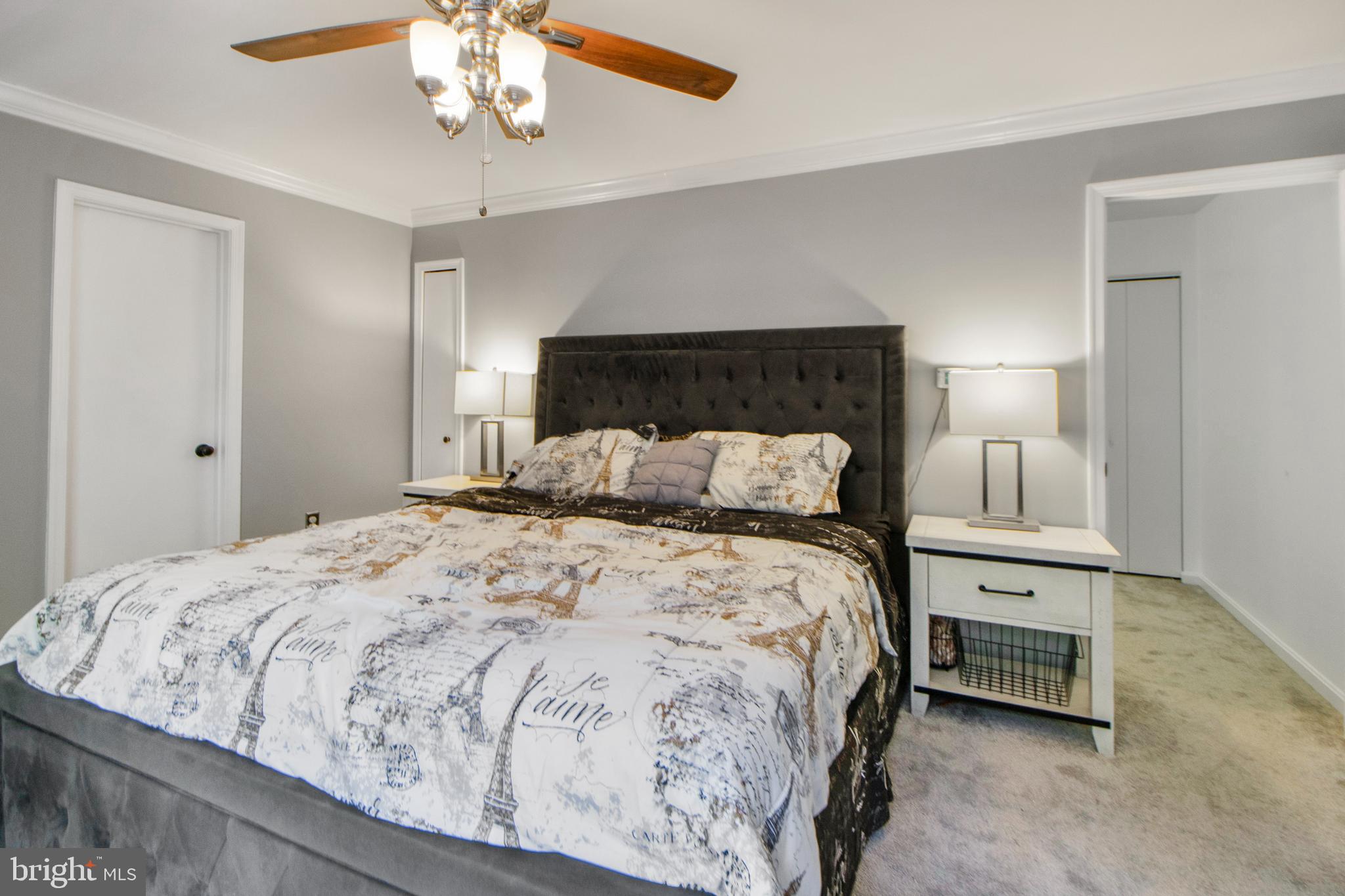 14432 Bakersfield Court Silver Spring, MD 20906 - Photo 37 of 60 a bedroom with a bed and a chandelier