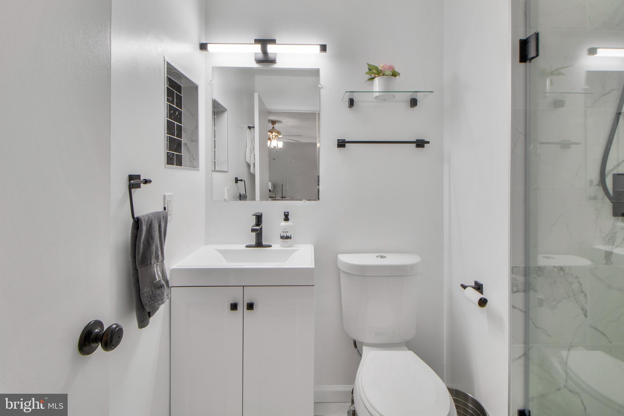 14432 Bakersfield Court Silver Spring, MD 20906 - Photo 38 of 60 a bathroom with a toilet sink and shower