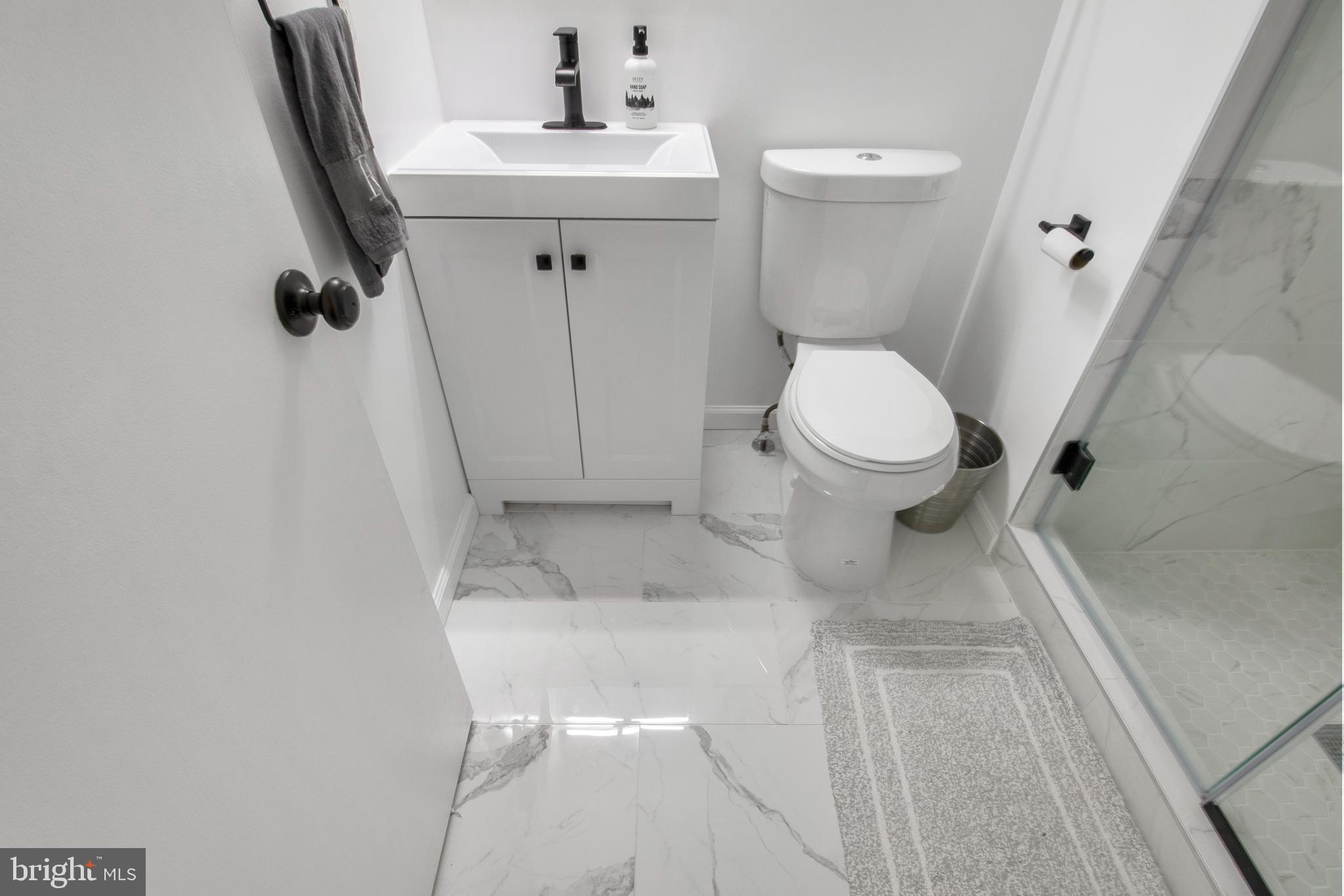 14432 Bakersfield Court Silver Spring, MD 20906 - Photo 39 of 60 a bathroom with a sink toilet and a mirror