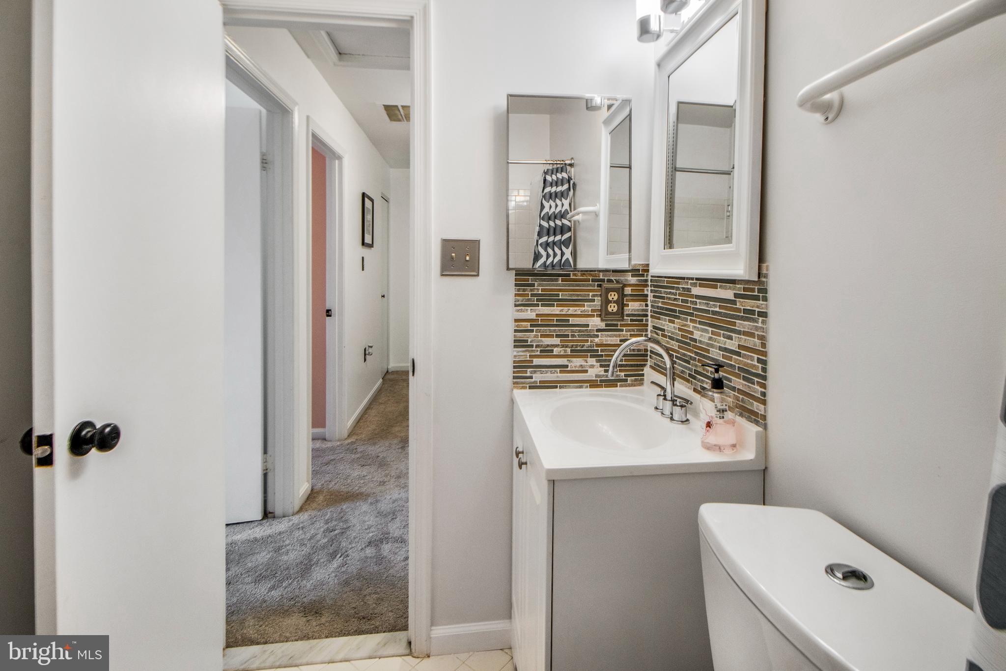 14432 Bakersfield Court Silver Spring, MD 20906 - Photo 42 of 60 a bathroom with a sink toilet and shower