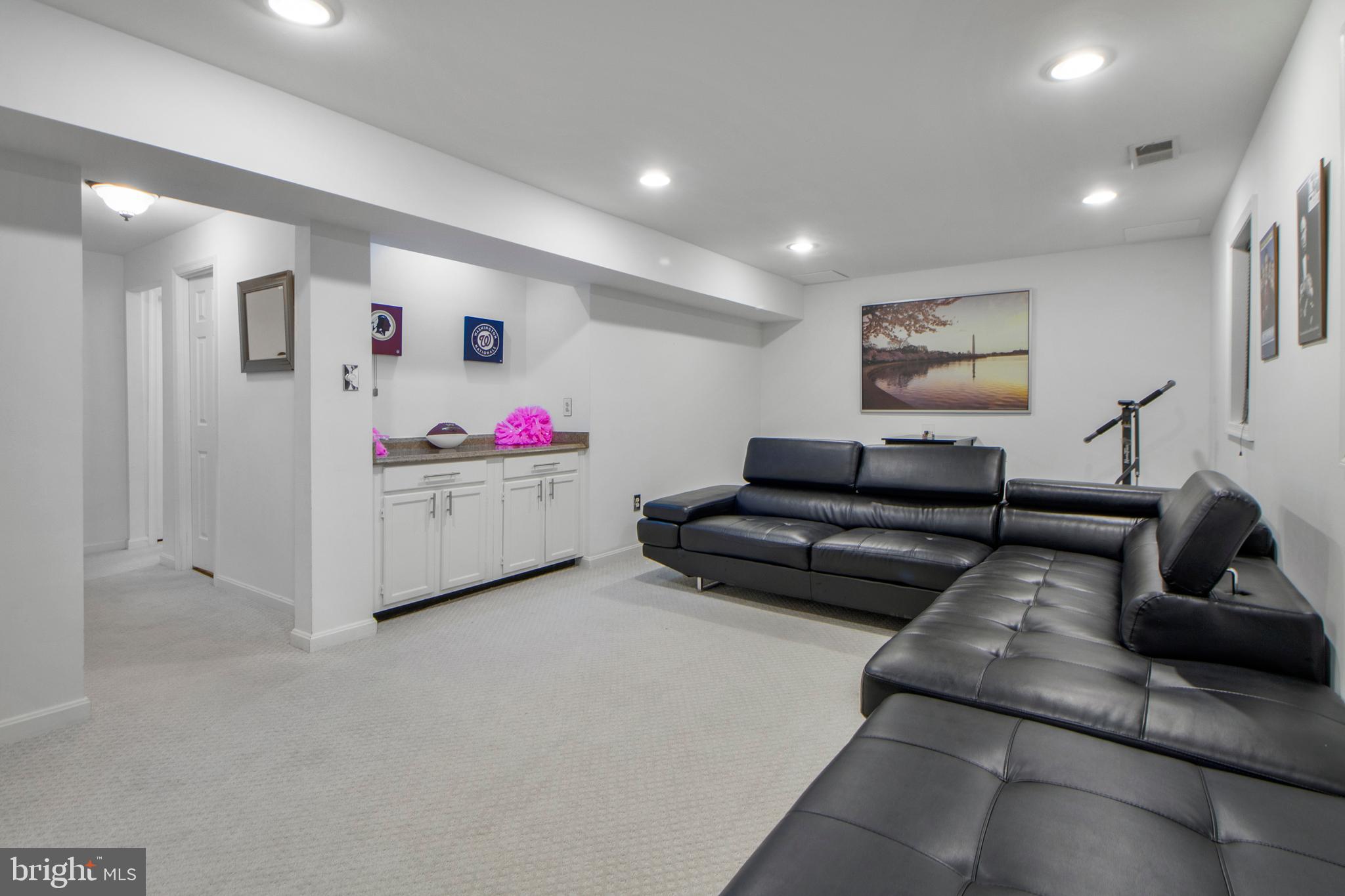 14432 Bakersfield Court Silver Spring, MD 20906 - Photo 50 of 60 a living room with furniture and a flat screen tv