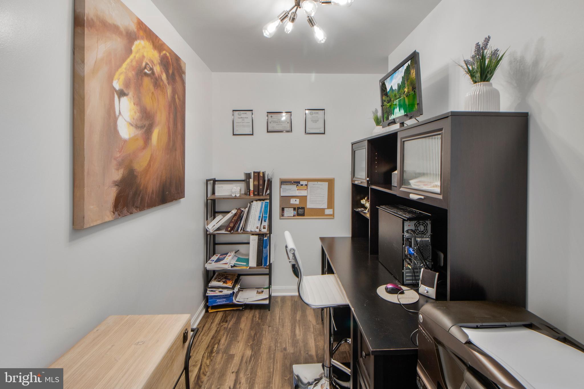 14432 Bakersfield Court Silver Spring, MD 20906 - Photo 53 of 60 a living room with furniture a flat screen tv and a table
