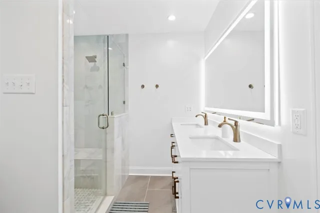 a bathroom with a sink shower and a mirror