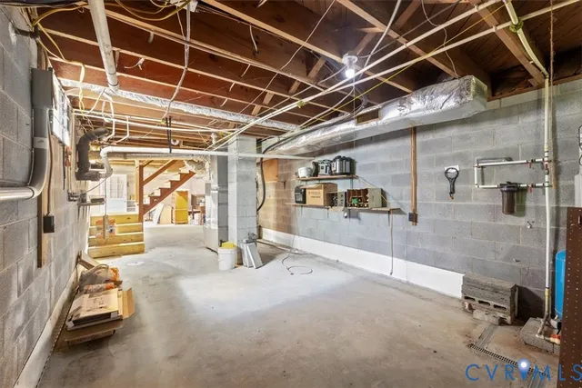 a view of a house with a yard and large tree