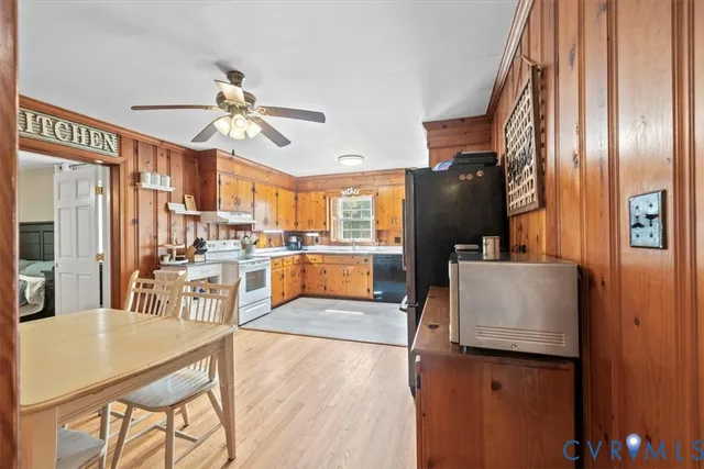 a living room with stainless steel appliances kitchen island granite countertop furniture and a view of kitchen