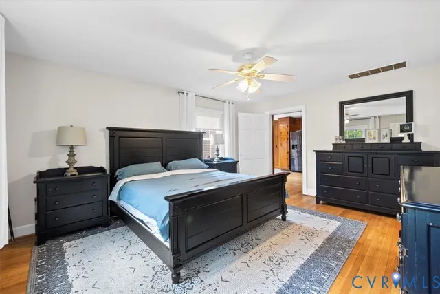 a bedroom with a bed lamp and dresser