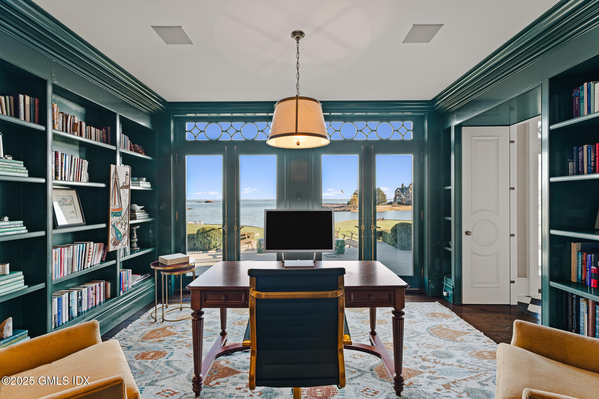 545 Indian Field Road Greenwich, CT 06830 - Photo 16 of 39 a workspace with furniture and a book shelf