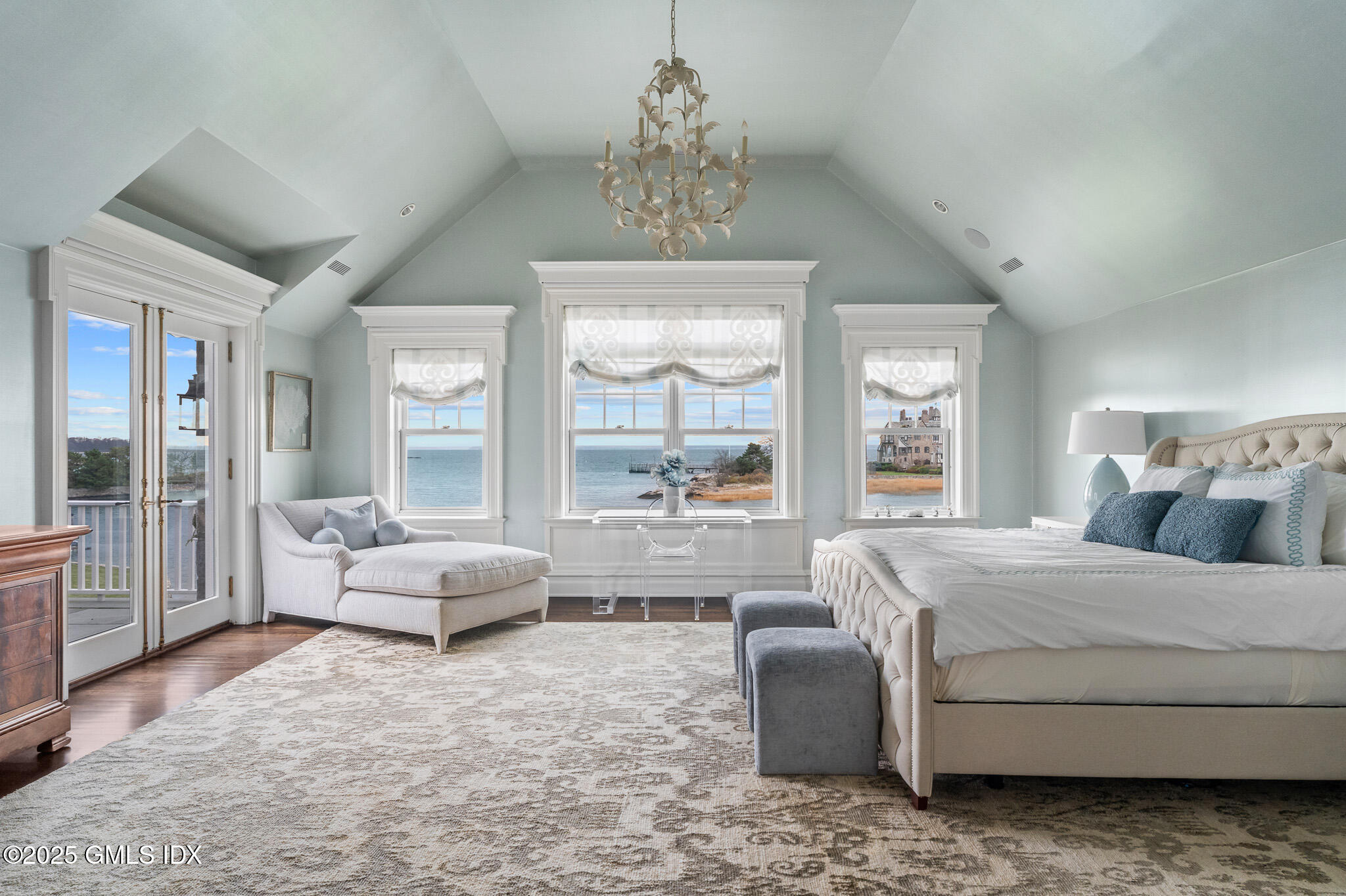 545 Indian Field Road Greenwich, CT 06830 - Photo 18 of 39 a bedroom with a bed and large windows