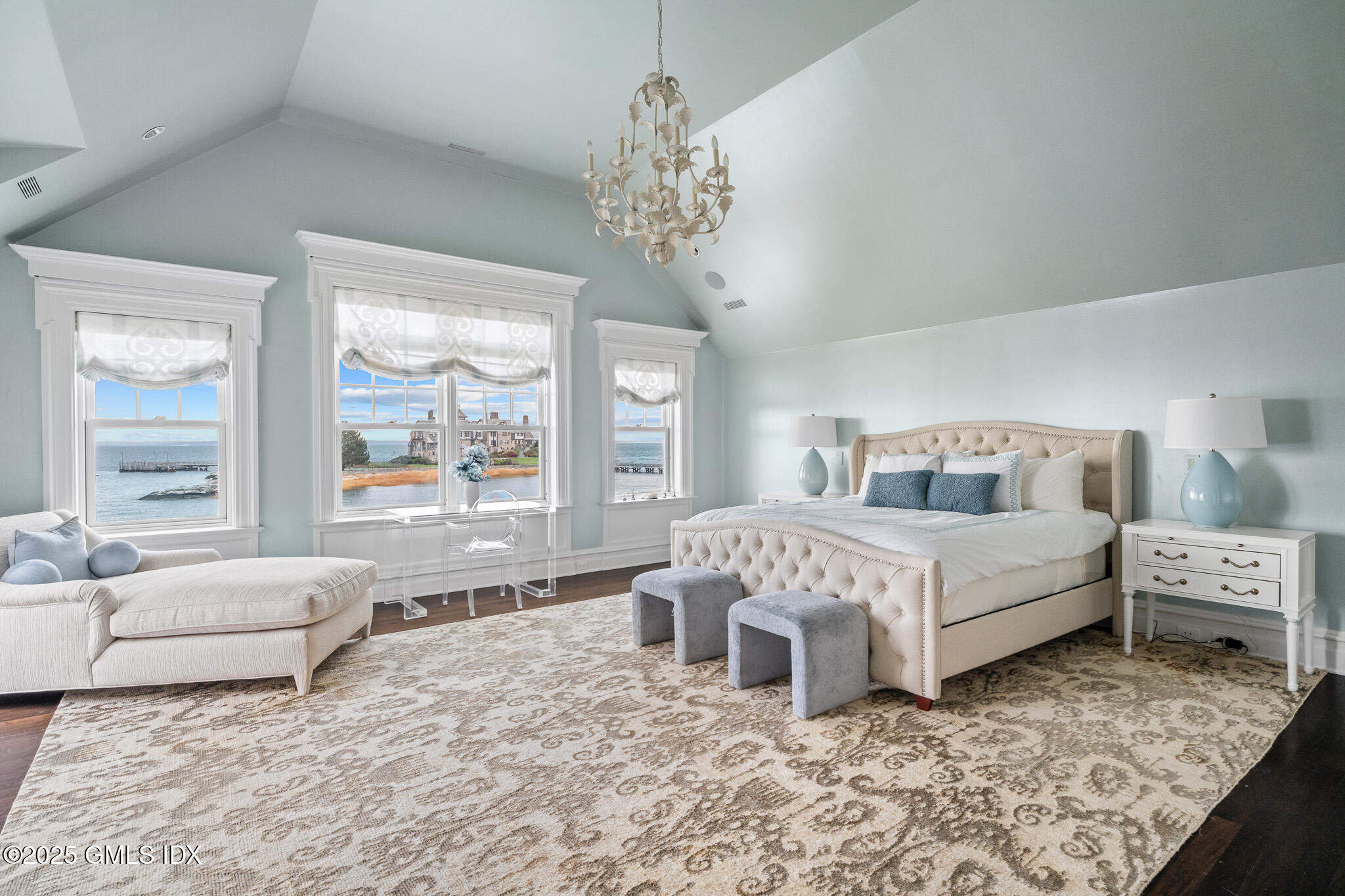 545 Indian Field Road Greenwich, CT 06830 - Photo 19 of 39 a bedroom with a large bed and a chandelier