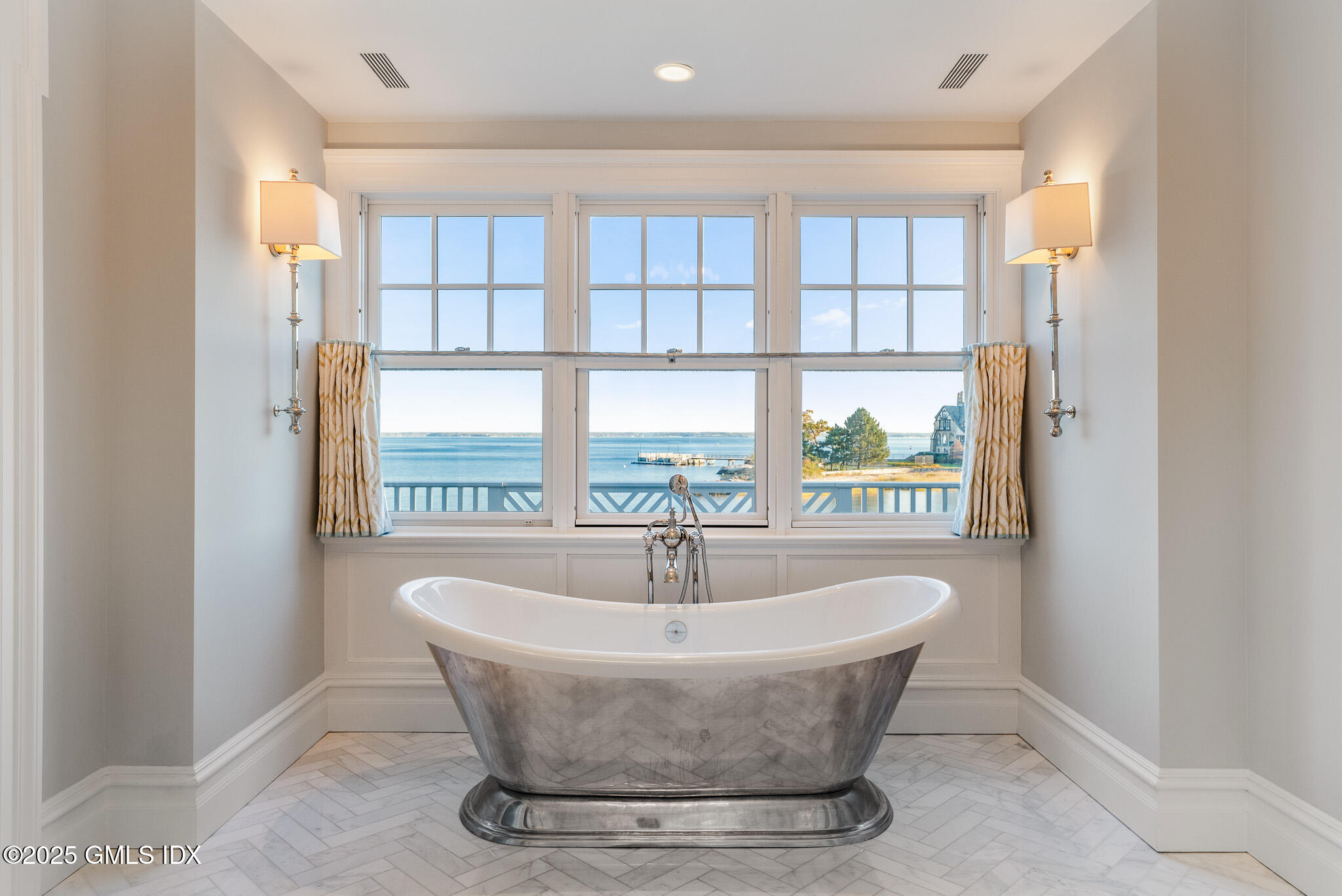 545 Indian Field Road Greenwich, CT 06830 - Photo 25 of 39 a white bath tub sitting in a bathroom next to a window