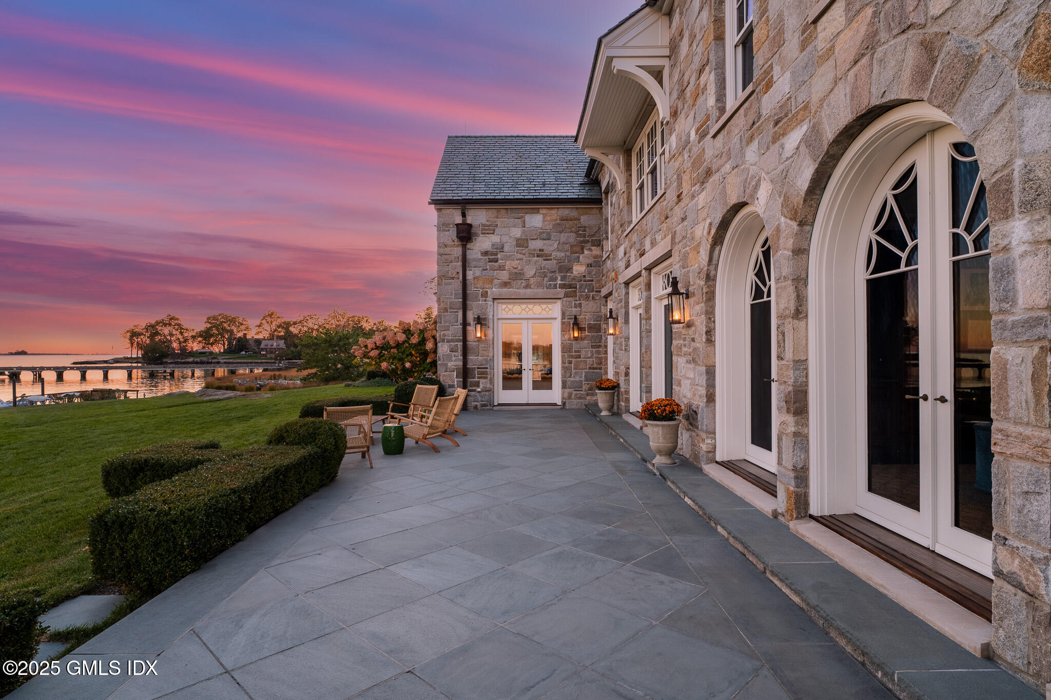 545 Indian Field Road Greenwich, CT 06830 - Photo 33 of 39 a view of a patio with a table and chairs