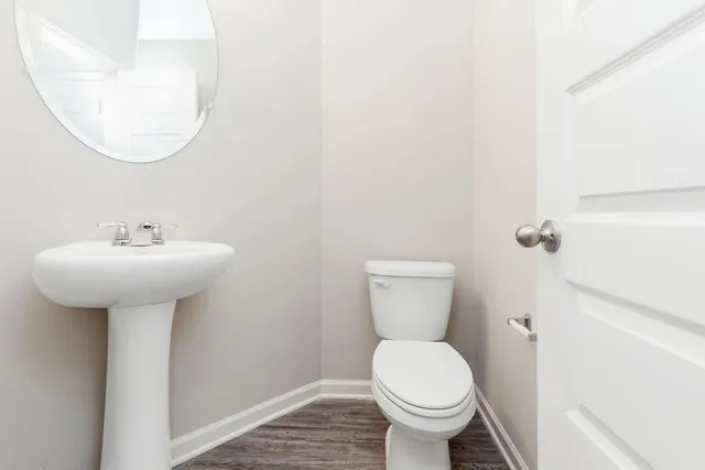 a bathroom with a sink toilet and a mirror