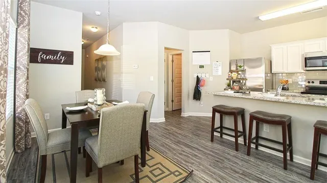 a dining room with furniture and wooden floor
