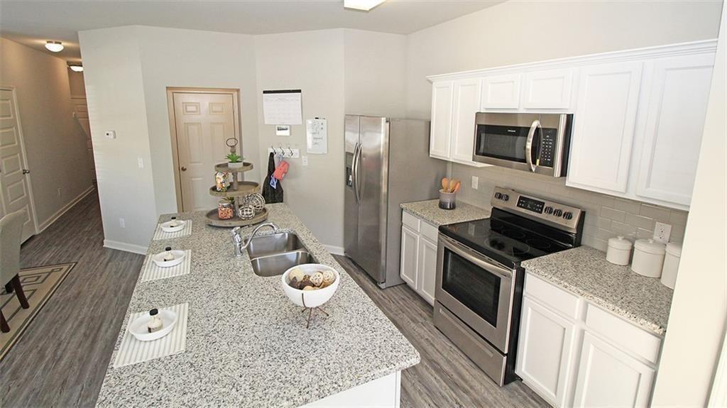 3577 Brycewood Drive Decatur, GA 30034 - Photo 6 of 13 a kitchen with stainless steel appliances granite countertop a stove refrigerator and a microwave