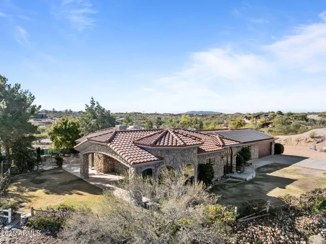 an aerial view of a house with a yard and balcony