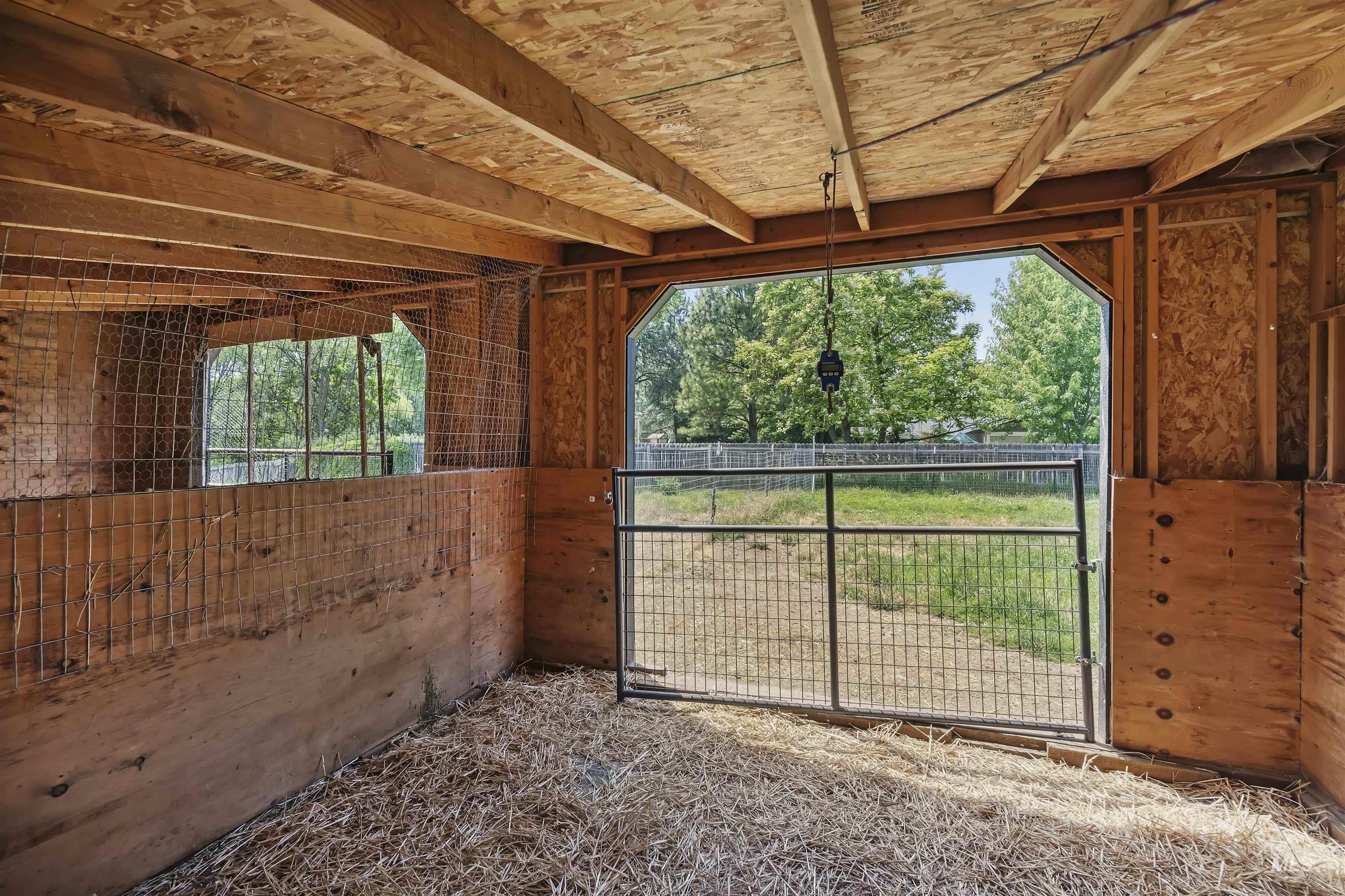 355 East Beacon Light Road Eagle, ID 83616 - Photo 33 of 47 Interior space featuring exposed wood beams, plywood wall construction, and a metal wire partition