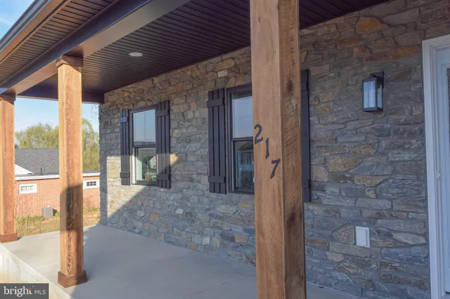 a view of a hallway with a glass door and an entryway