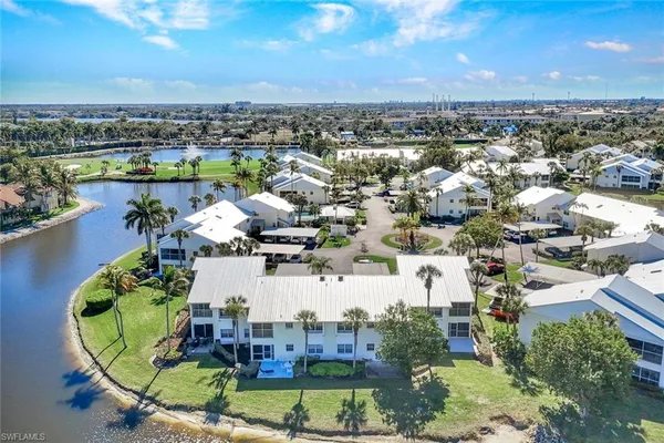 an aerial view of a house with a lake view