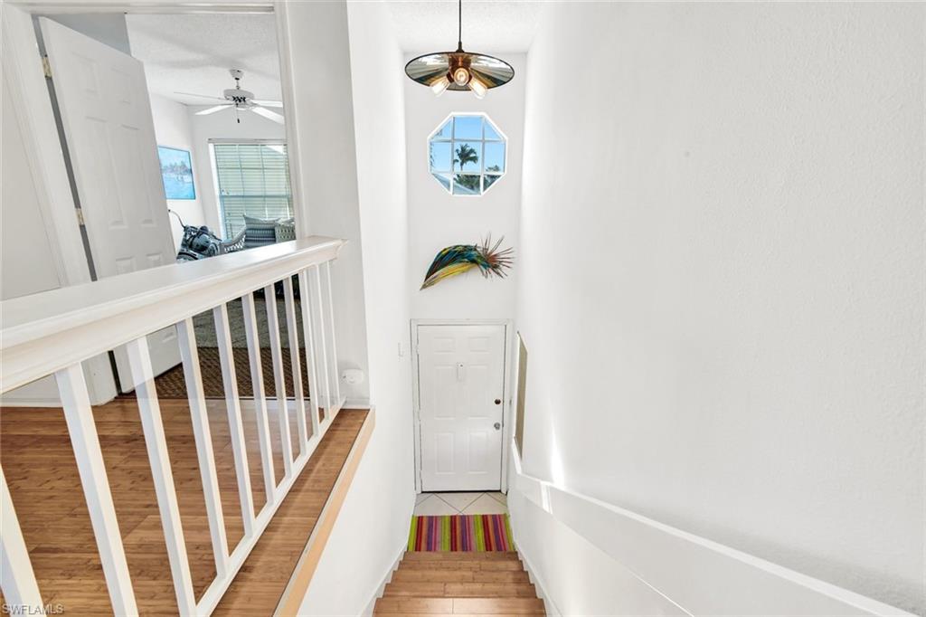 14985 Rivers Edge Court, Unit 236 Fort Myers, FL 33908 - Photo 15 of 33 a view of a hallway with wooden floor and a dining table