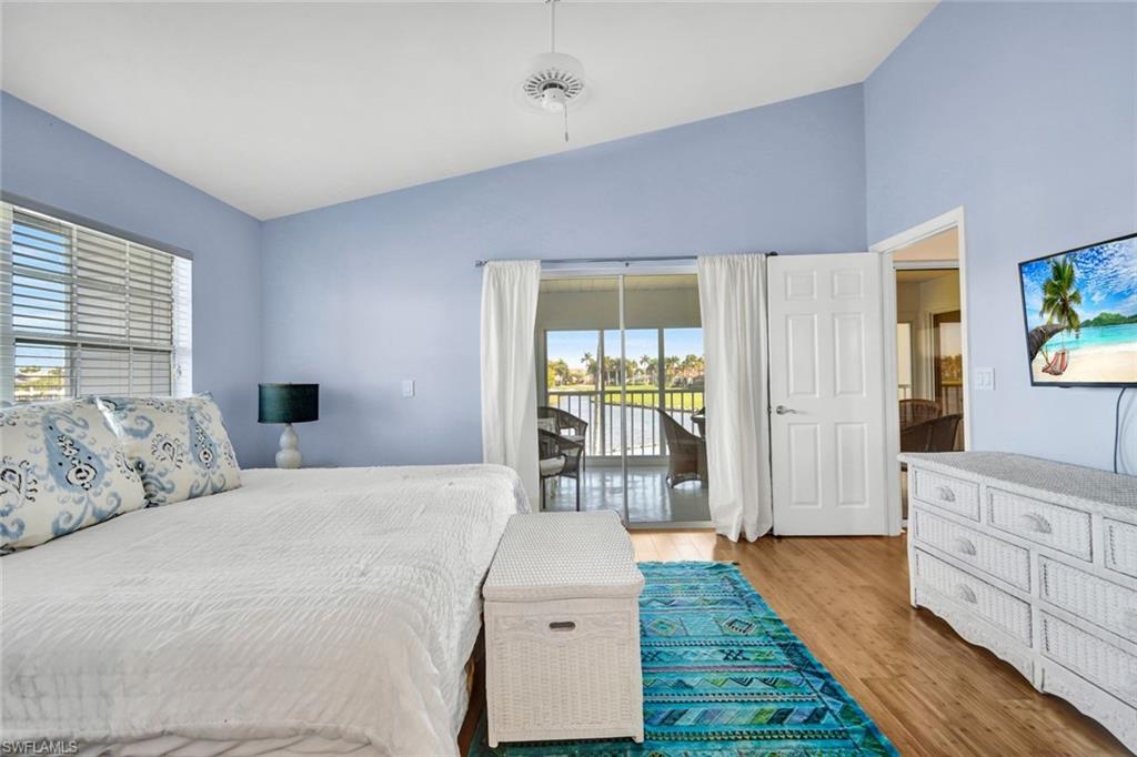 14985 Rivers Edge Court, Unit 236 Fort Myers, FL 33908 - Photo 17 of 33 a bedroom with a bed and wooden floor