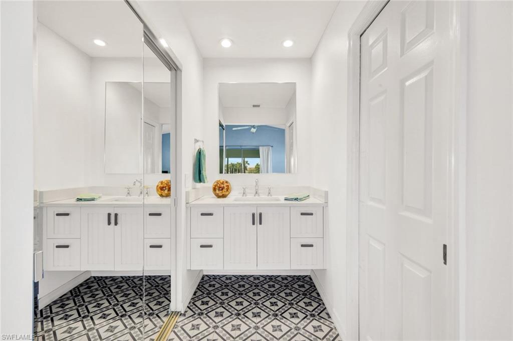 14985 Rivers Edge Court, Unit 236 Fort Myers, FL 33908 - Photo 19 of 33 a bathroom with mirror sink and toilet