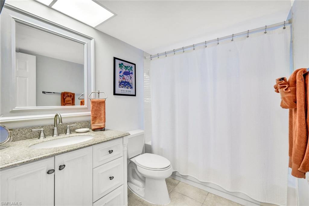14985 Rivers Edge Court, Unit 236 Fort Myers, FL 33908 - Photo 21 of 33 a bathroom with a sink a toilet and a mirror