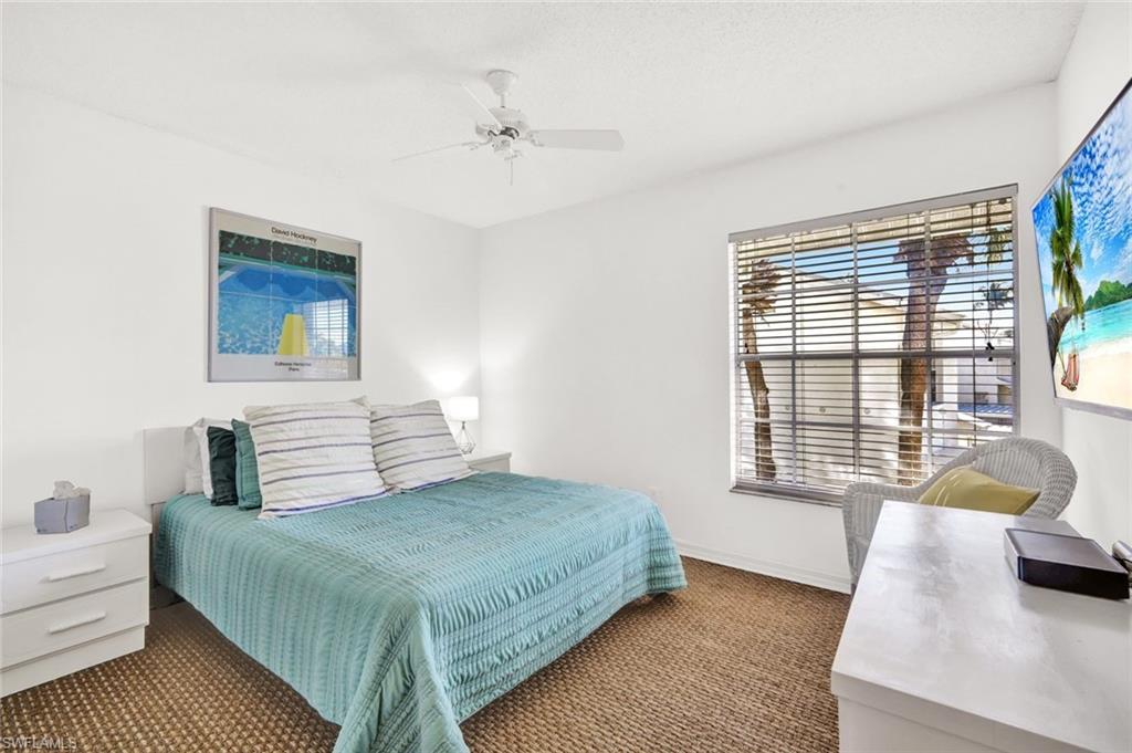 14985 Rivers Edge Court, Unit 236 Fort Myers, FL 33908 - Photo 22 of 33 a bedroom with a bed and a couch