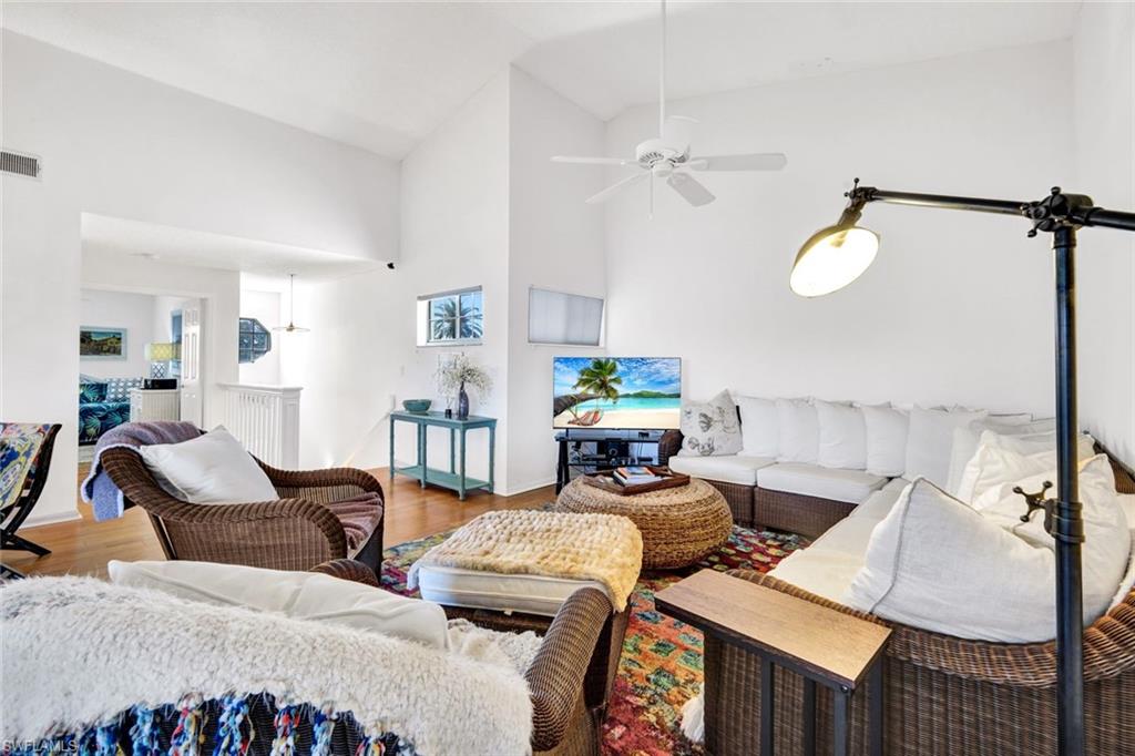 14985 Rivers Edge Court, Unit 236 Fort Myers, FL 33908 - Photo 9 of 33 a living room with furniture and wooden floor