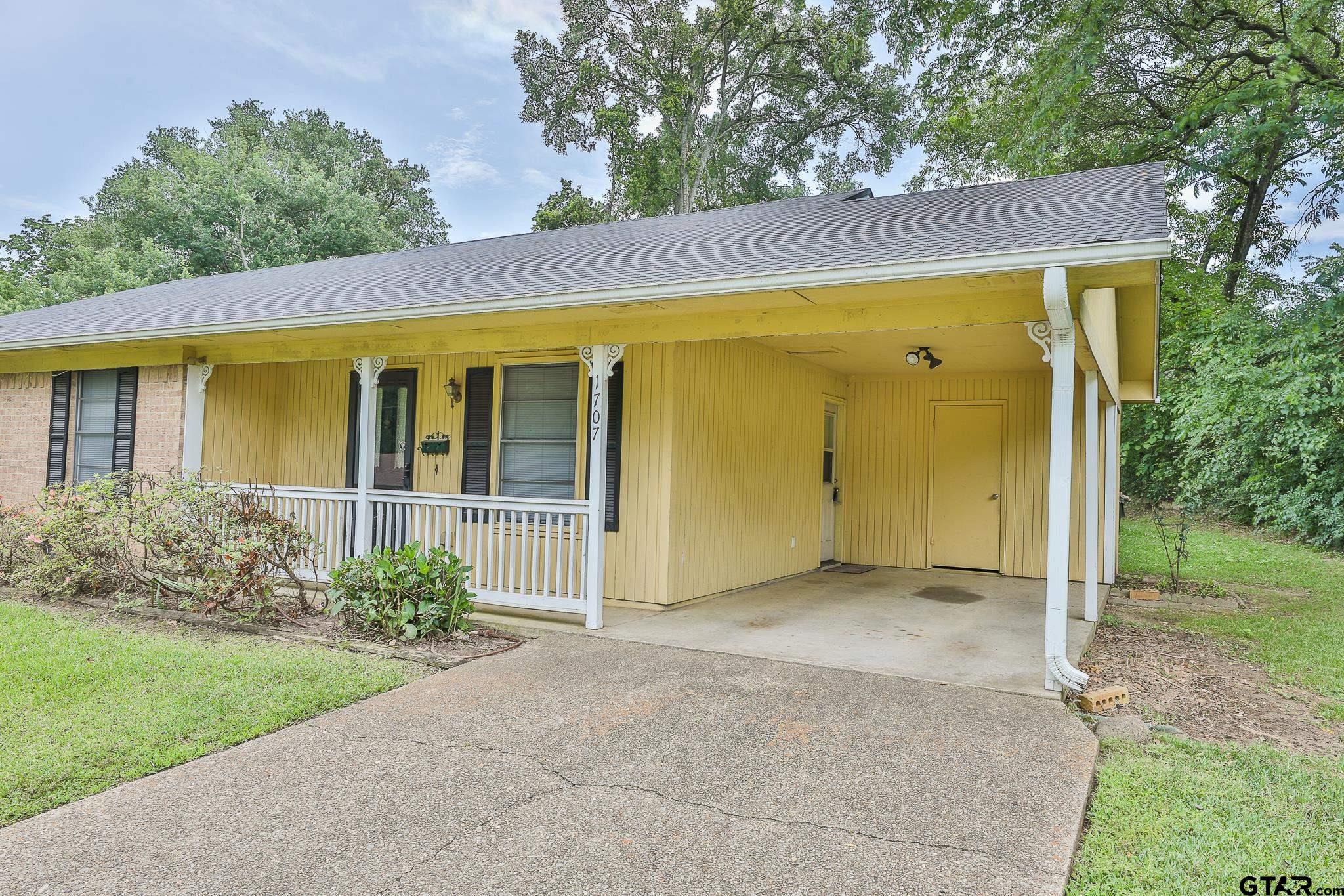 1707 Sampson Drive Tyler, TX 75701 - Photo 3 of 24 a view of a house with backyard and garden